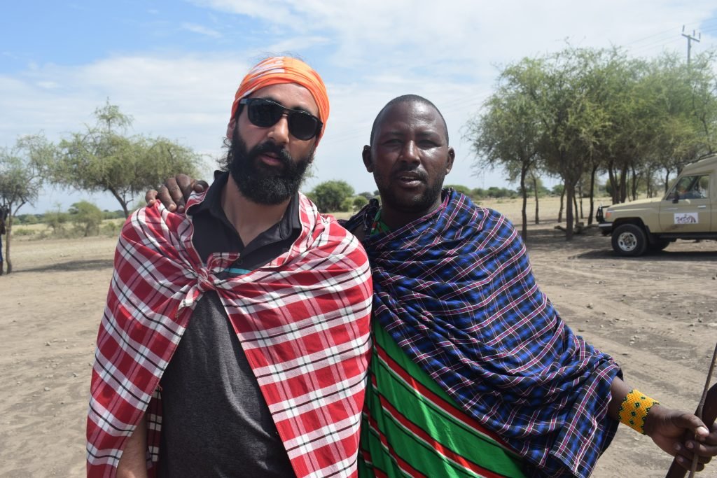 An image to display Tado travel guest with maasai man on Culture safari